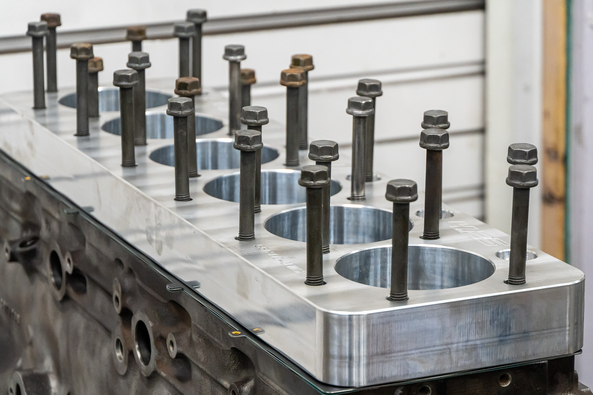 Machined diesel engine block with head studs, ready for reassembly