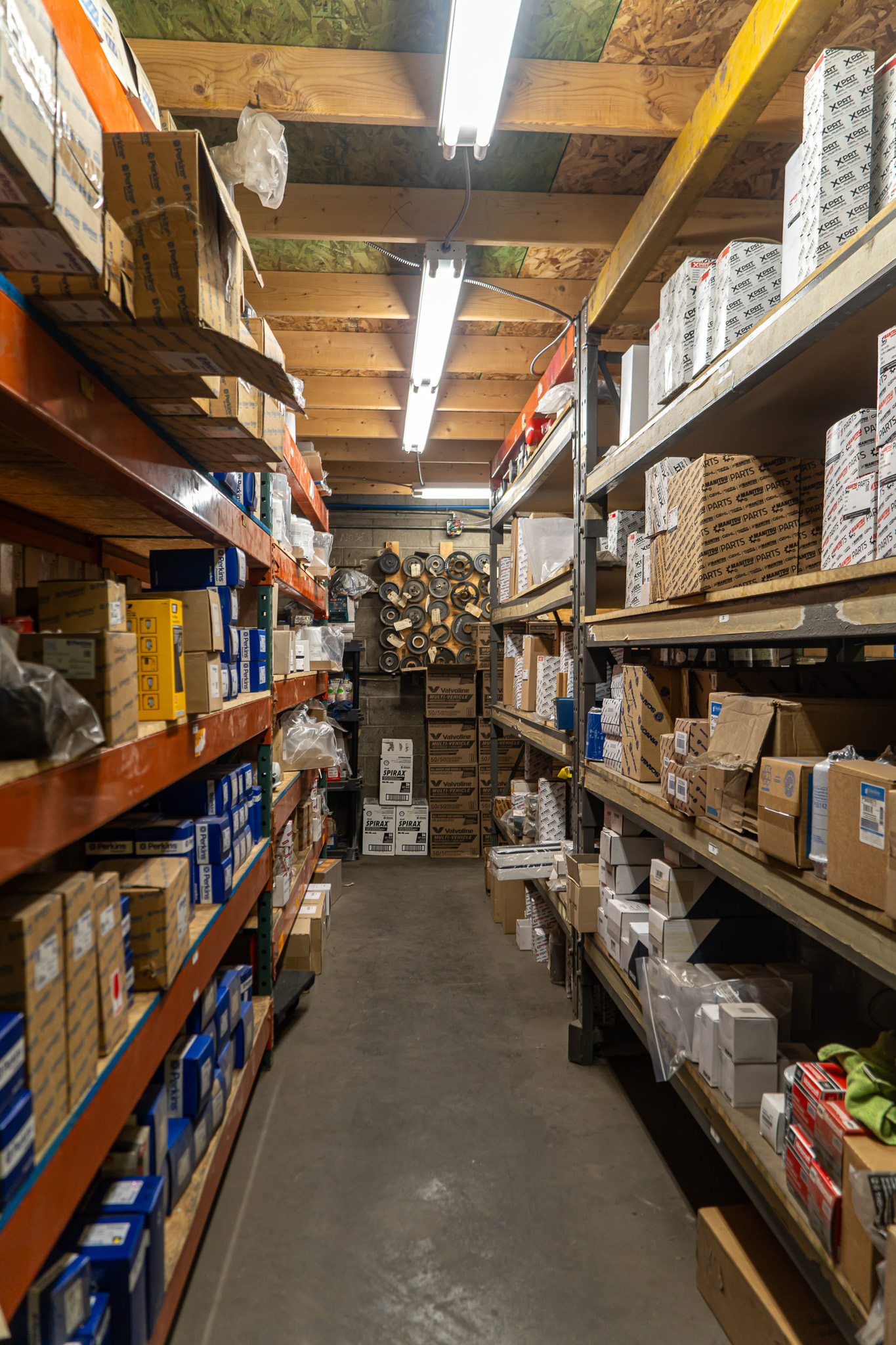 Aisle of parts shelves stocked with diesel engine parts at Bluegrass Diesel Specialists